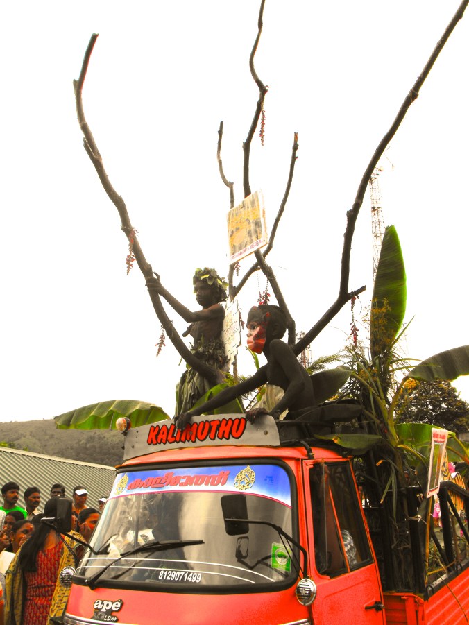 Parade float with children dressed as plants and animals