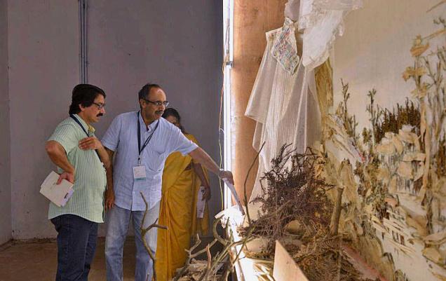 V. Venu, director-general of the National Museum in Delhi (in blue), viewing Xu Bing’s work at Aspinwall House  in Kochi on Sunday.
