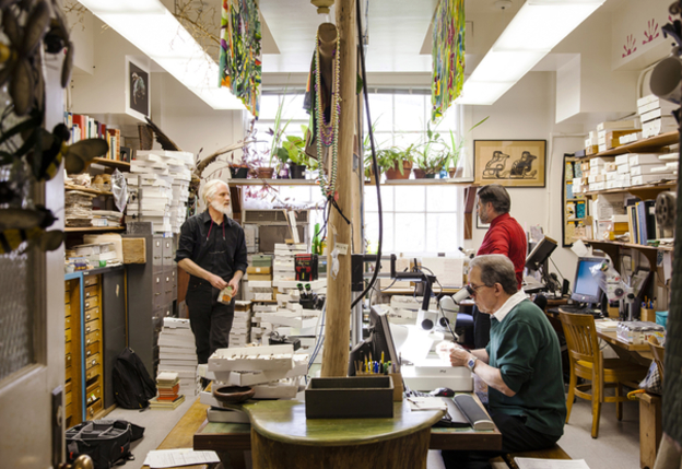 In Droege's lab at the Patuxent Wildlife Research Center, pizza boxes provide storage to thousands of pinned bee specimens. Volunteers Gene Scarpulla (in green) and Tim McMahon peer through microscopes to ID the insects.  Credit: Robert Wright