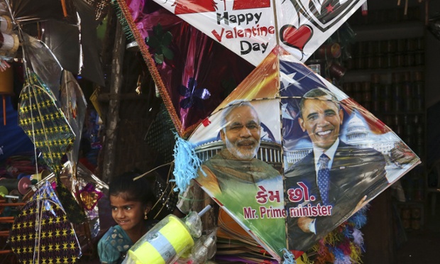 An Indian girl stands near a kite with portraits of India’s Prime Minister Narendra Modi and US President Barack Obama, displayed for sale at a shop ahead of the Hindu festival of Makar Sankranti, also knowns as kite festival, in Hyderabad, India, 12 January 2015. Photograph: Mahesh Kumar A./AP