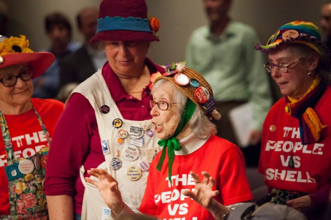 A protester opposes allowing Royal Dutch Shell drilling rigs to dock in Seattle on their way to Alaska. Credit David Ryder for The New York Times