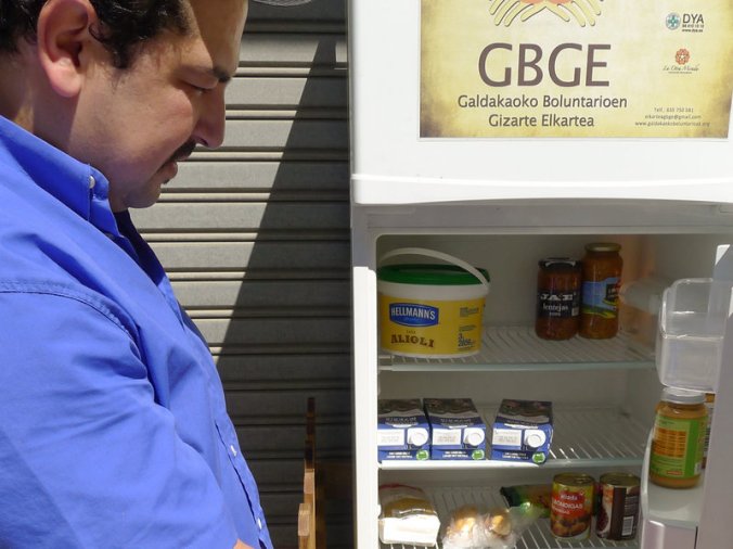 Issam Massaoudi, an unemployed Moroccan immigrant, checks out what's inside the Solidarity Fridge. Massaoudi says money is tight for him, and it's 