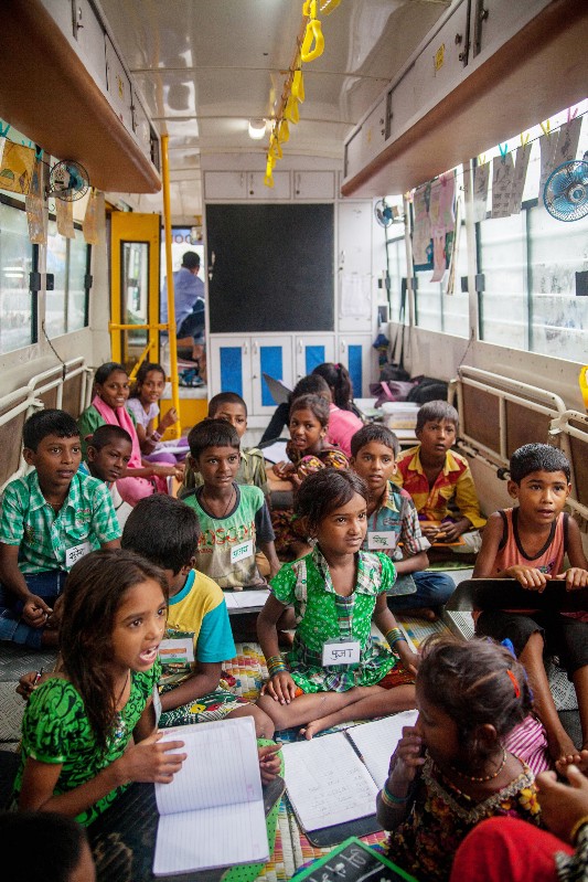  The buses can only hold 20 students, without much space to wiggle around or store books. But they have unique benefits — like their ability to reach many of Mumbai’s poorest migrants who live on illegal plots of land where schools can’t be built. PHOTO: Karen Dias