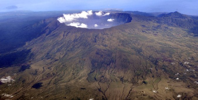 The deep volcanic crater, top, was produced by the eruption of Mount Tambora in Indonesia in April 1815 - the most powerful volcanic blast in recorded history. PHOTO: Iwan Setiyawan/KOMPAS, via Associated Press