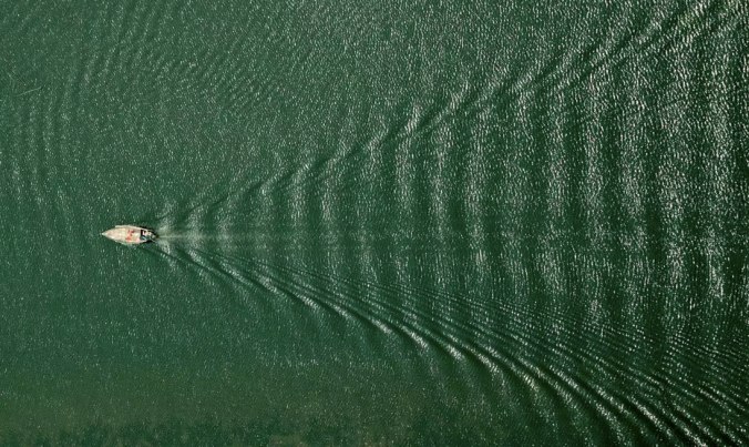 "This was somewhere over Meghna river, most probably over Narshingdi. I was looking for a shot when I noticed the boat splitting the waves and heading strong like an arrow. I was smiling while pressing the shutter – this is one of my favourite pictures." Photo credit: Shamim Shorif Susom